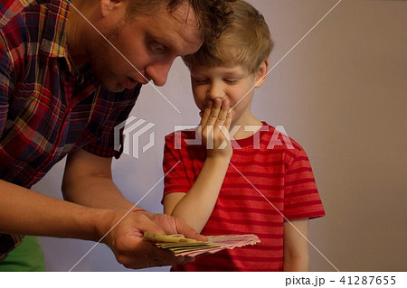 Man and boy hold money in their hands 41287655