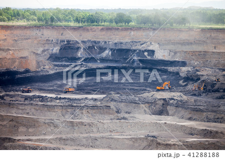 Dump trucks and excavator working at coal mine Dump trucks and excavator working at coal mine 41288188