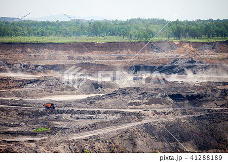 Dump trucks working at open coal mine 41288189