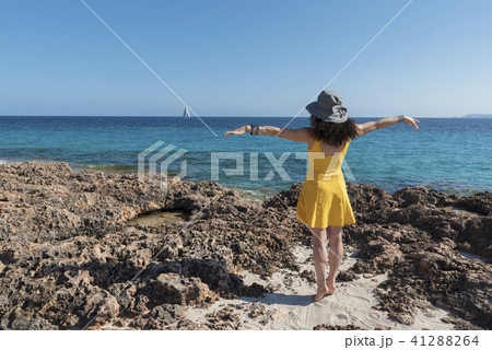 Yellow dressed woman on a beach. Selective focus Yellow dressed woman on a beach. Selective focus 41288264