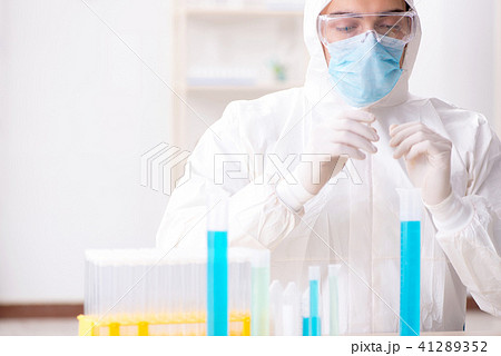 Young chemist student working in lab on chemicals 41289352
