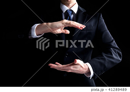 Man holding his hands out and showing something Man holding his hands out and showing something 41289489
