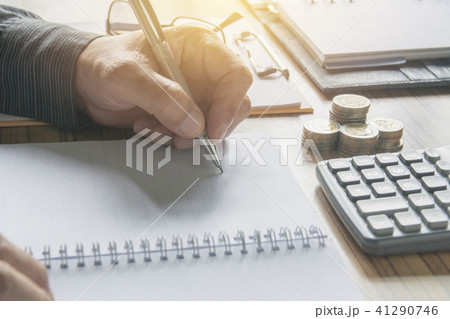 Businessman working and writing on notebook Businessman working and writing on notebook 41290746