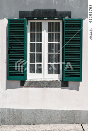 Ornamental facade of colorful house in Sao Miguel, Azores. Portugal. Beautiful old tiny houses Ornamental facade of colorful house in Sao Miguel, Azores. Portugal. Beautiful old tiny houses 41291763