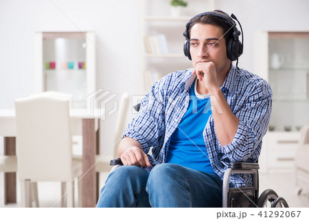 Disabled man listening to music in wheelchair Disabled man listening to music in wheelchair 41292067