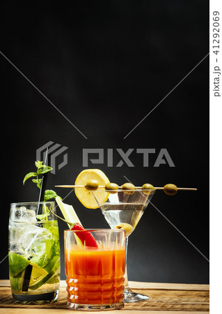martini drink with olive and mojito with mint and bloody mary with celery 41292069