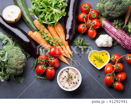 Mix of raw vegetables with salt, spices on dark Mix of raw vegetables with salt, spices on dark 41292491