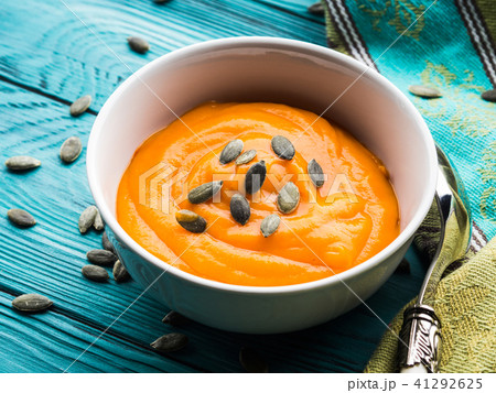 Creamy pumpkin soup in white bowls Creamy pumpkin soup in white bowls 41292625