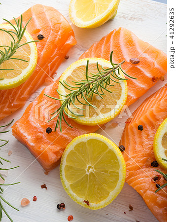 Raw salmon on wooden board with herbs Raw salmon on wooden board with herbs 41292635