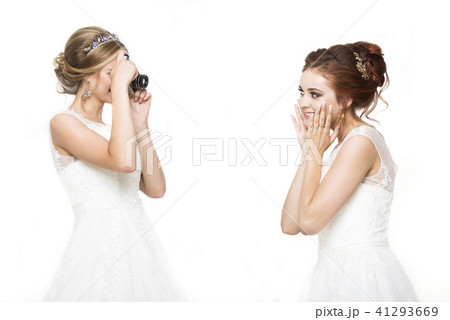 Two young pretty brides making wedding photo 41293669