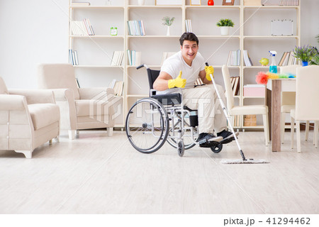 Disabled man cleaning floor at home Disabled man cleaning floor at home 41294462