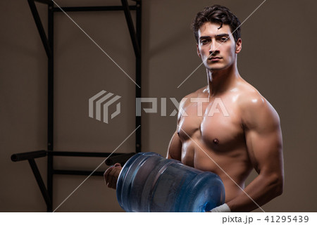Muscular ripped man with big water bottle Muscular ripped man with big water bottle 41295439