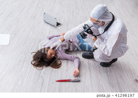 Forensic investigator at the crime scene investigating woman mur 41296197