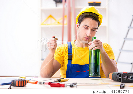 Drunk engineer working in the workshop 41299772