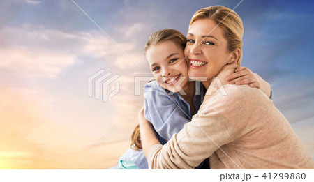 happy smiling mother hugging daughter over sky 41299880