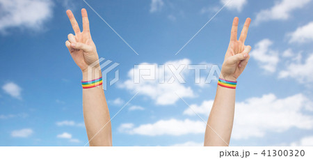 hands with gay pride rainbow wristbands make peace 41300320