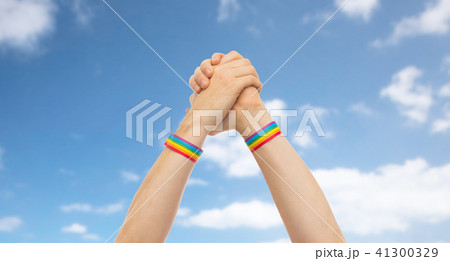 hands with gay pride wristbands in winning gesture 41300329