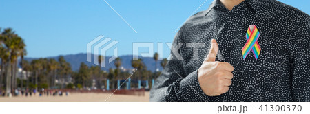 man with gay pride rainbow awareness ribbon 41300370