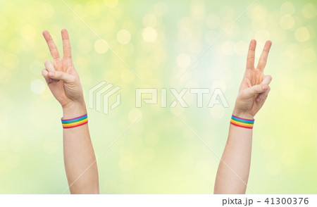 hands with gay pride rainbow wristbands make peace 41300376
