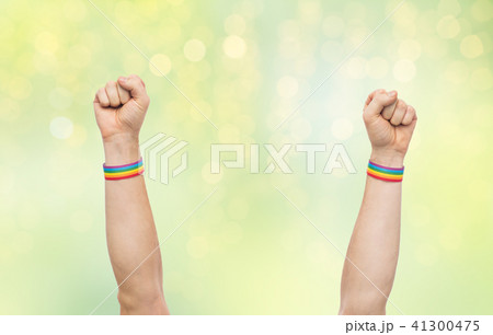 hands with gay pride rainbow wristbands shows fist 41300475
