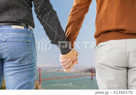 close up of male gay couple holding hands 41300579