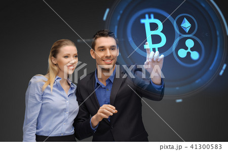businesspeople with cryptocurrency holograms businesspeople with cryptocurrency holograms 41300583