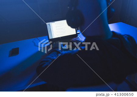 hacker with coding on laptop computer in dark room hacker with coding on laptop computer in dark room 41300650