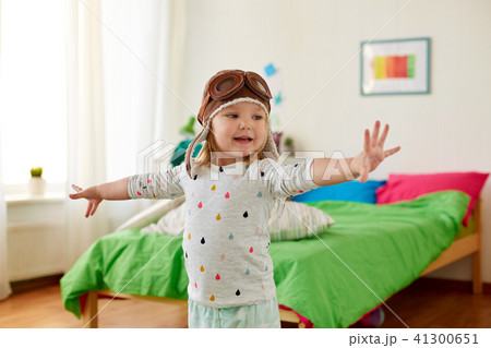 happy little girl in pilot hat playing at home happy little girl in pilot hat playing at home 41300651