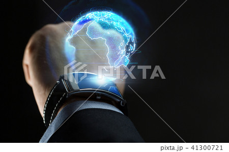 hand with smart watch and earth hologram 41300721