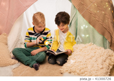 happy boys reading book in kids tent at home 41300726