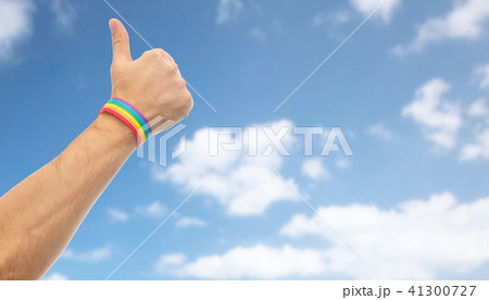 hand with gay pride rainbow wristband shows thumb hand with gay pride rainbow wristband shows thumb 41300727