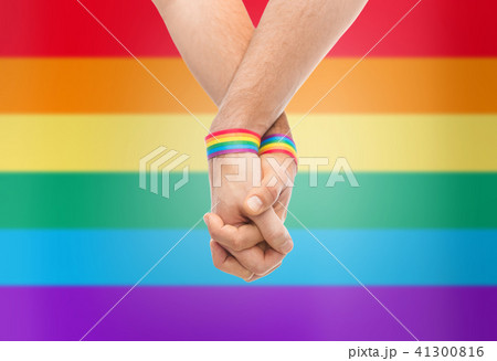 hands of couple with gay pride rainbow wristbands hands of couple with gay pride rainbow wristbands 41300816