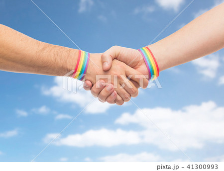 hands with gay pride wristbands make handshake 41300993