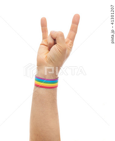 hand with gay pride rainbow wristband shows rock 41301207
