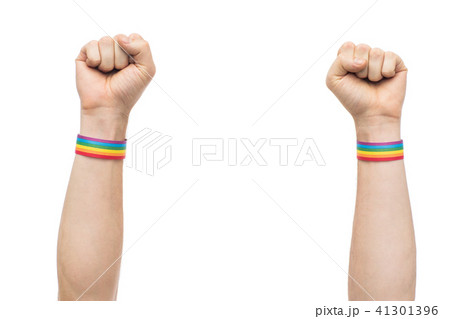 hands with gay pride rainbow wristbands shows fist 41301396