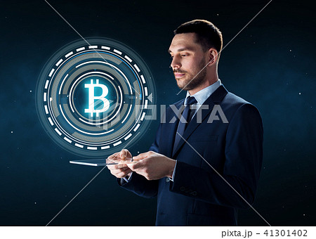 businessman with tablet pc and bitcoin hologram 41301402