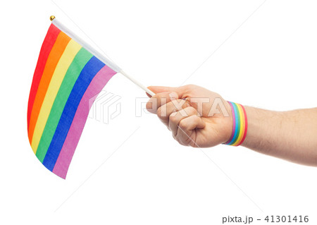 hand with gay pride rainbow flag and wristband 41301416