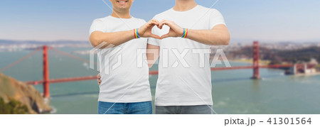 couple with gay pride rainbow wristbands and heart 41301564