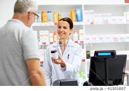 apothecary and senior customer at pharmacy apothecary and senior customer at pharmacy 41301607