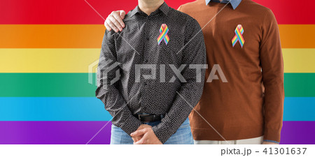 close up of couple with gay pride rainbow ribbons 41301637