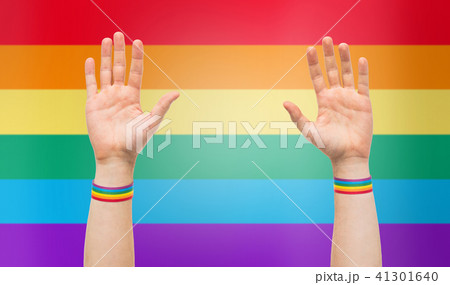 hands with gay pride rainbow wristbands 41301640