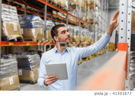businessman with tablet pc at warehouse businessman with tablet pc at warehouse 41301677