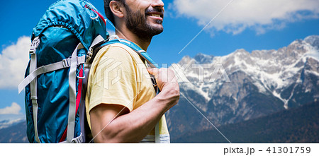 close up of man with backpack over alps mountains 41301759