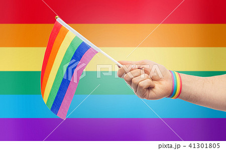 hand with gay pride rainbow flag and wristband 41301805