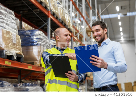 worker and businessman with clipboard at warehouse worker and businessman with clipboard at warehouse 41301910