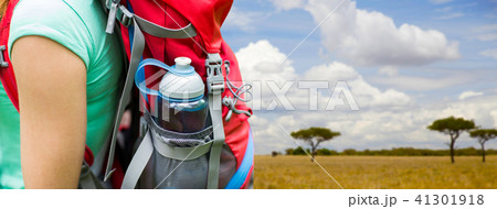 close up of woman with water bottle in backpack 41301918