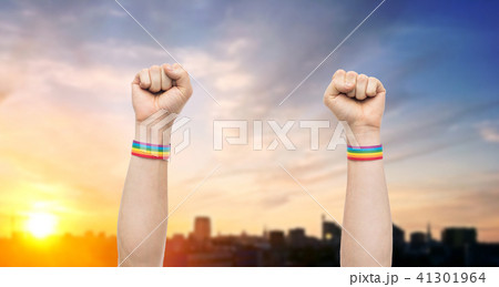 hands with gay pride rainbow wristbands shows fist 41301964
