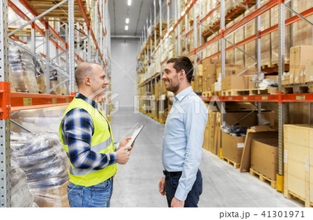 worker and businessman with clipboard at warehouse 41301971