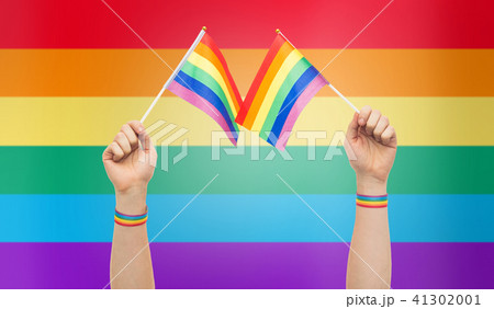 hand with gay pride rainbow flags and wristbands 41302001
