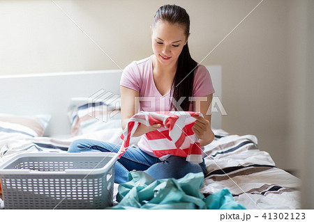 woman or housewife sorting laundry at home woman or housewife sorting laundry at home 41302123